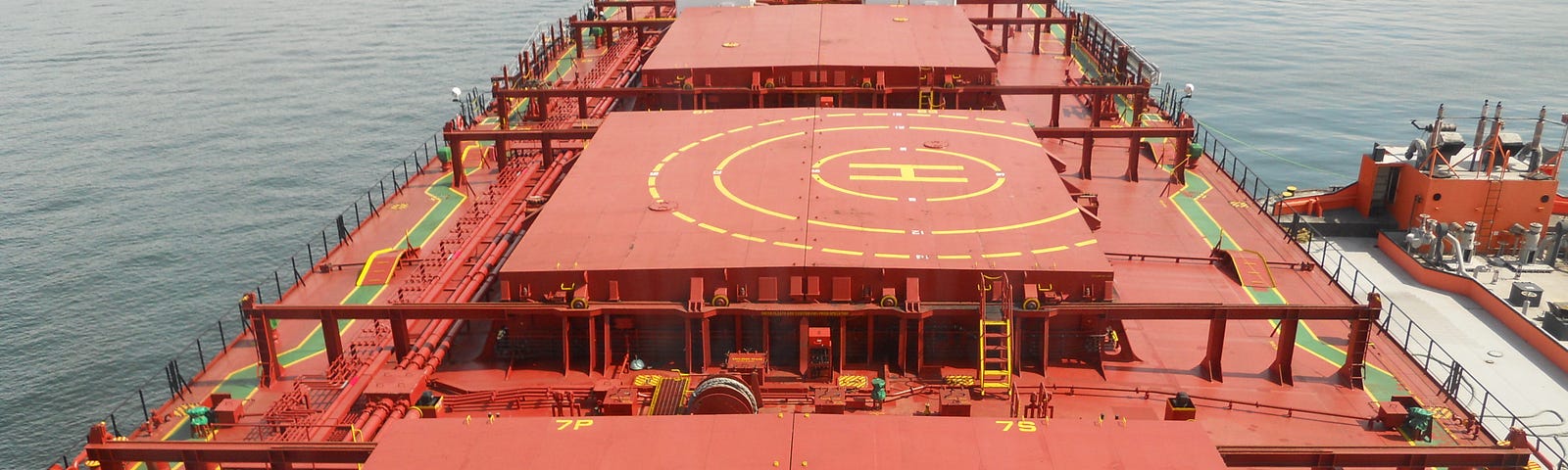 Orange colored massive holds of a cargo ship are shown