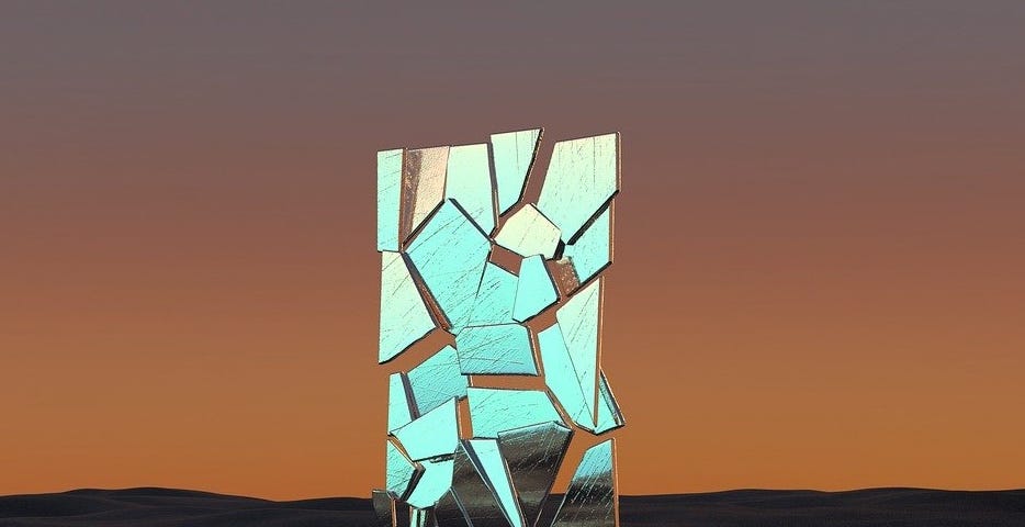 IMAGE: In a surreal landscape in brownish tones, a standing broken mirror