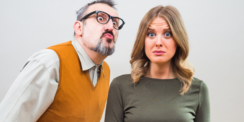 Man in glasses making funny face and woman with concerned expression — Is the “Seinfeld Syndrome” Sabotaging Your Dating Life?