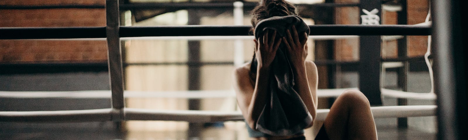 Woman drying face with towel