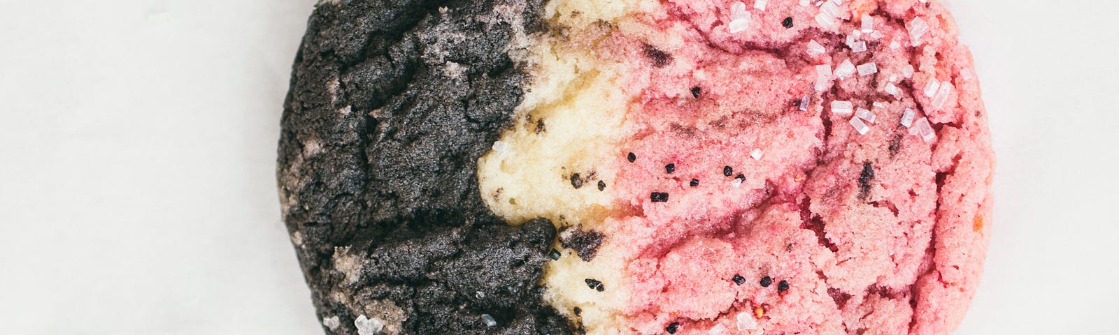 Closeup of four cookies that have brown, tan, and pink stripes.