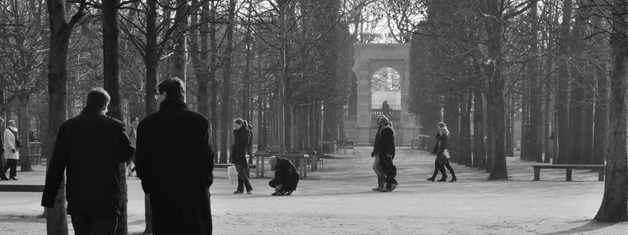 Two men walking in the Jardin des Tuileries, Paris.