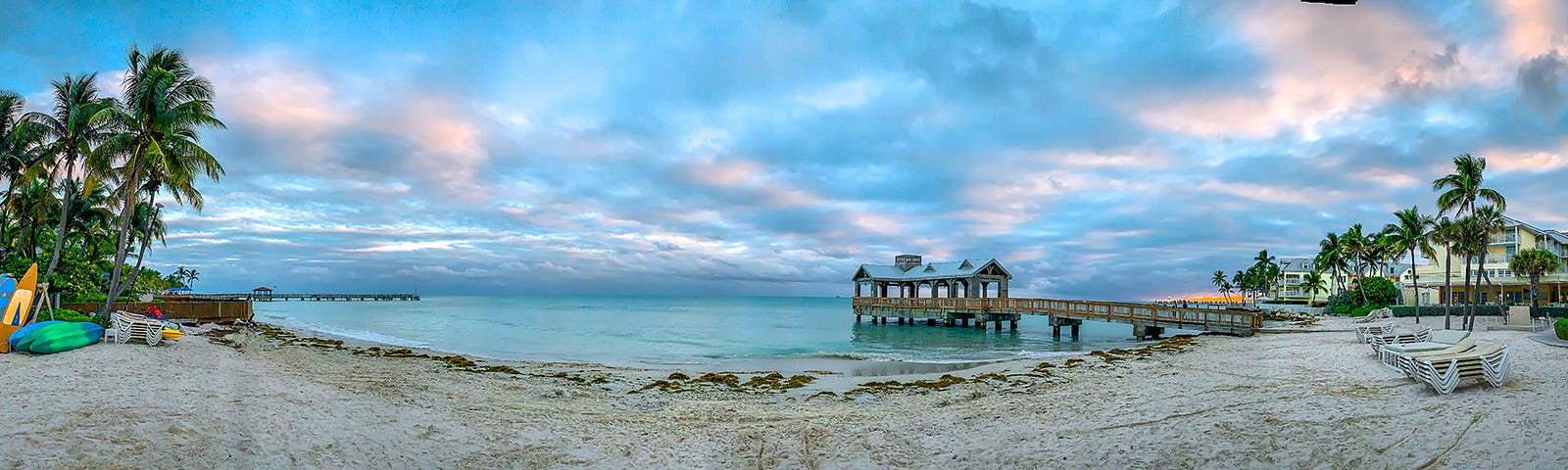 The sandy beach and and pier at The Reach Key West at sunset — just steps from our lodging.