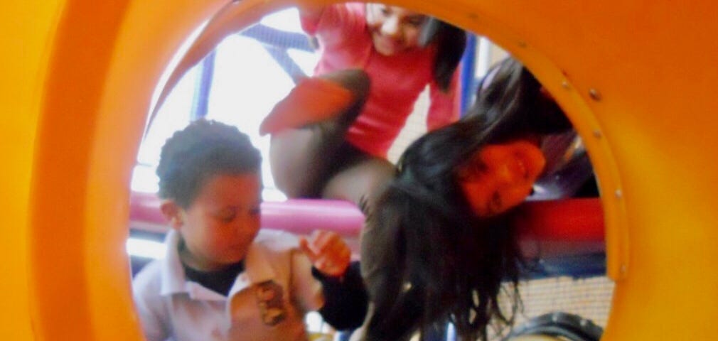 My son in play structure with two girls at McDonald’s.