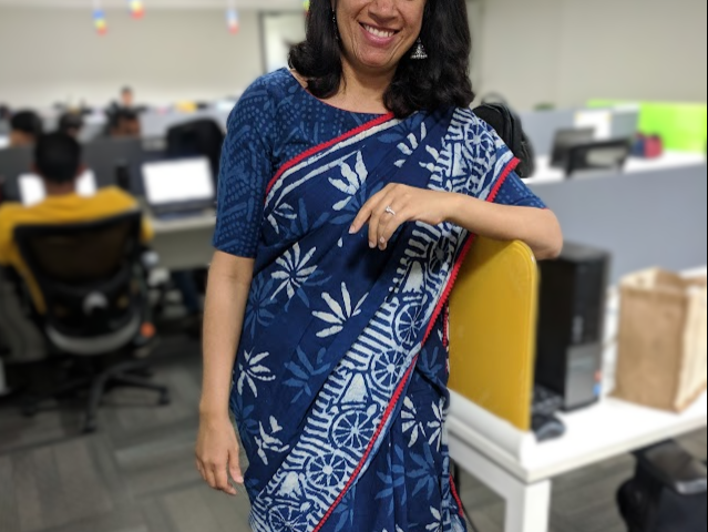 Photo of the author in a saree at her workplace.