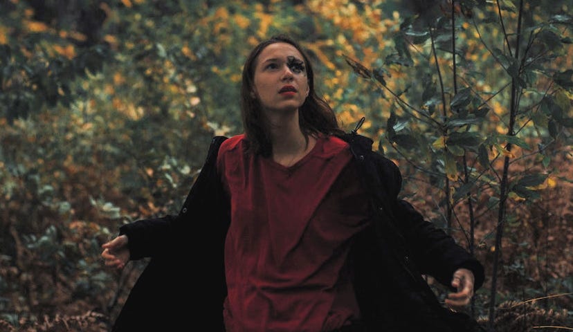 A woman in a forest.