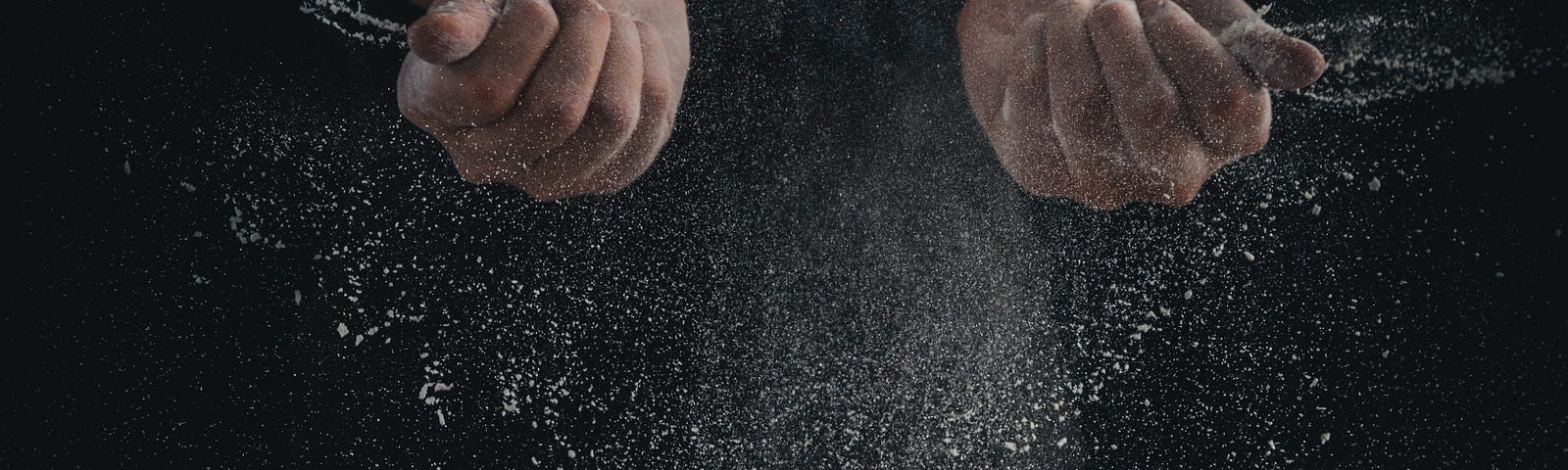The powder of flour falling off from the hands.