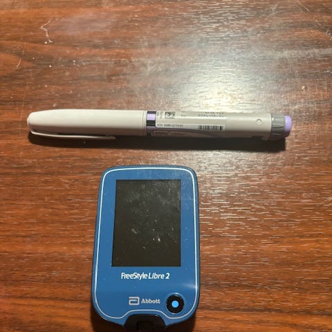 Picture of an insulin “pen” and a glucose reader