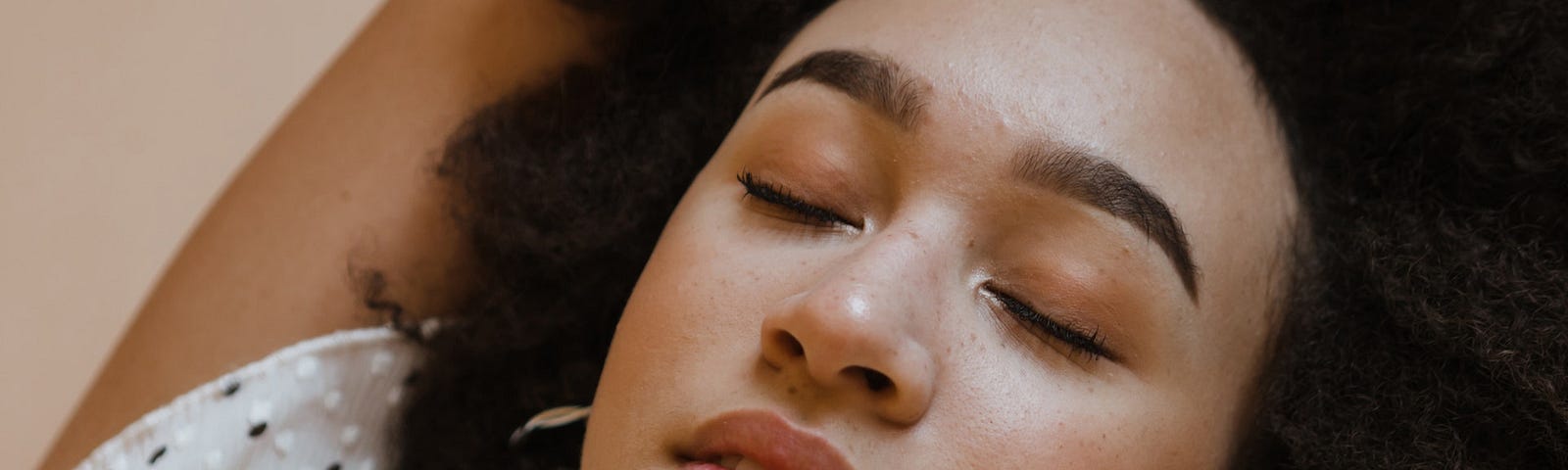 Peaceful woman relaxing with closed eyes