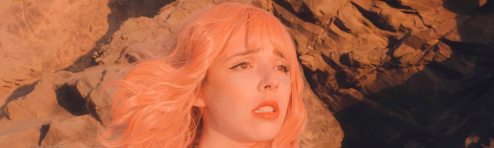 color photo of pink haired anxious looking person wearing white high collared shirt standing outside