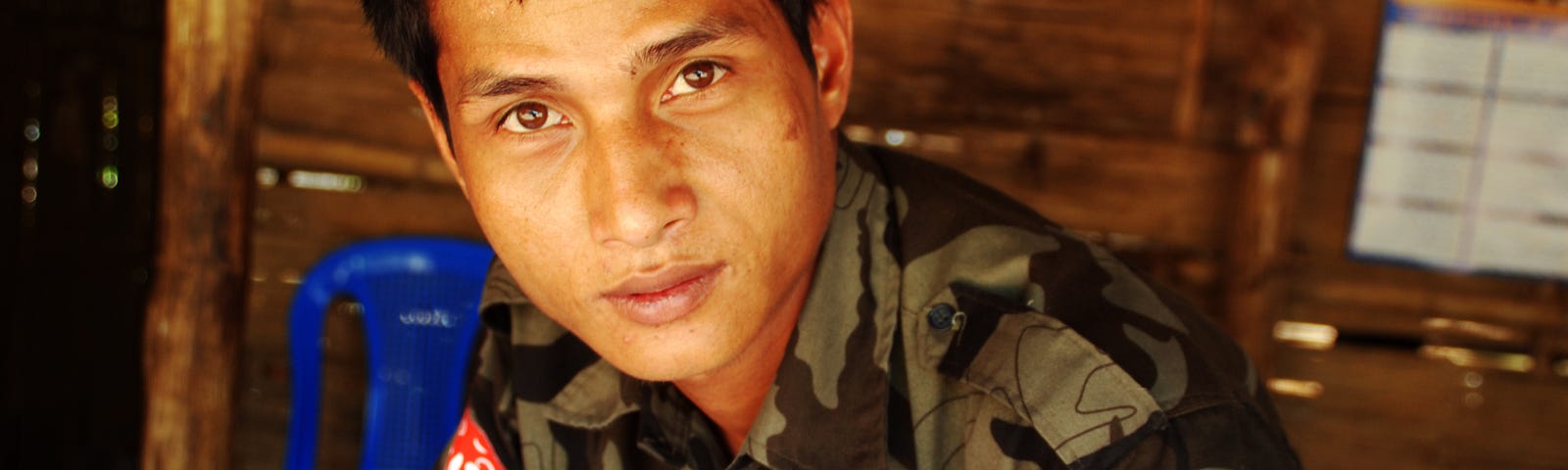 An Arakan Army soldier outside Laiza looks into the camera in Myanmar’s Kachin State in March 2014. Photo by David Brenner.