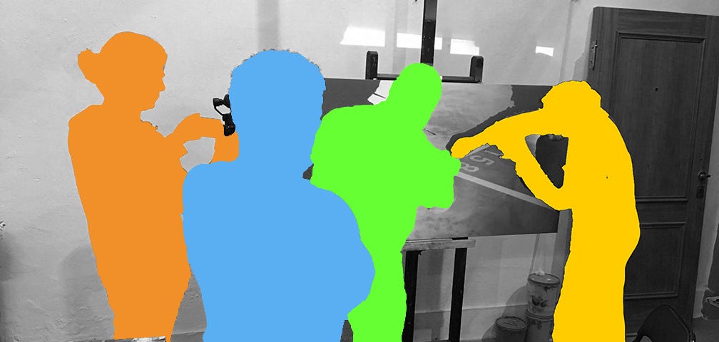 Four color figures in an art studio