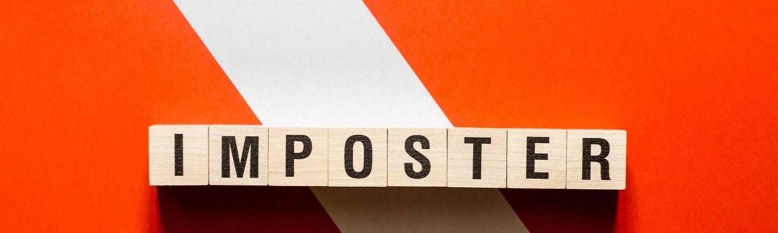 An orange and white warning sign with the word: IMPOSTER written in wooden scrabble letters.