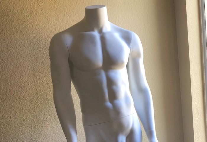 The torso and arms of a headless white male manniquin