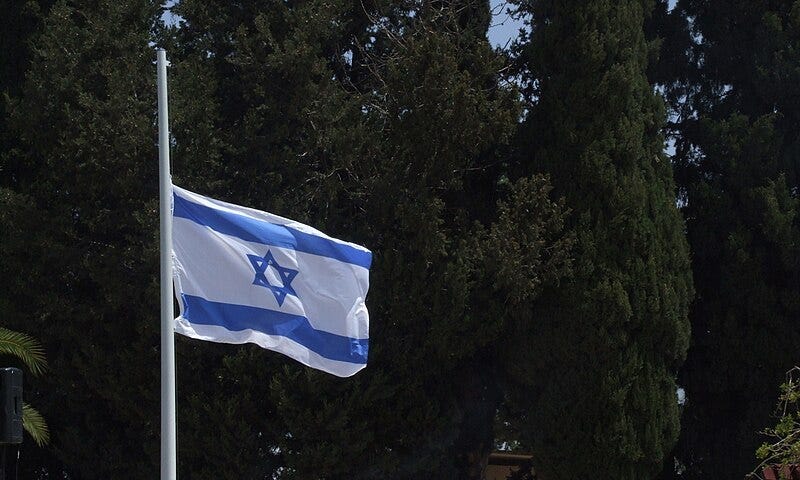 Photo the flag of Israel at half-staff at a military cemetery