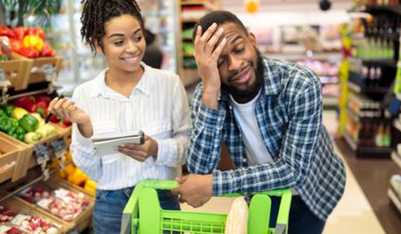 Picture of tired husband shopping with wife via alamy.com