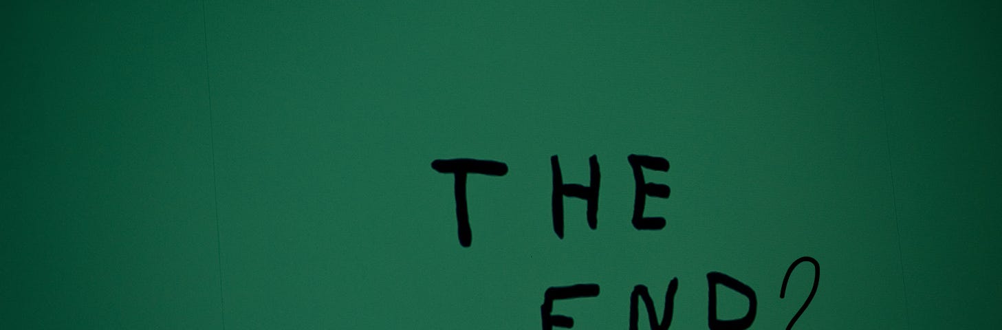 A photograph with the text “The End?” on a green background.