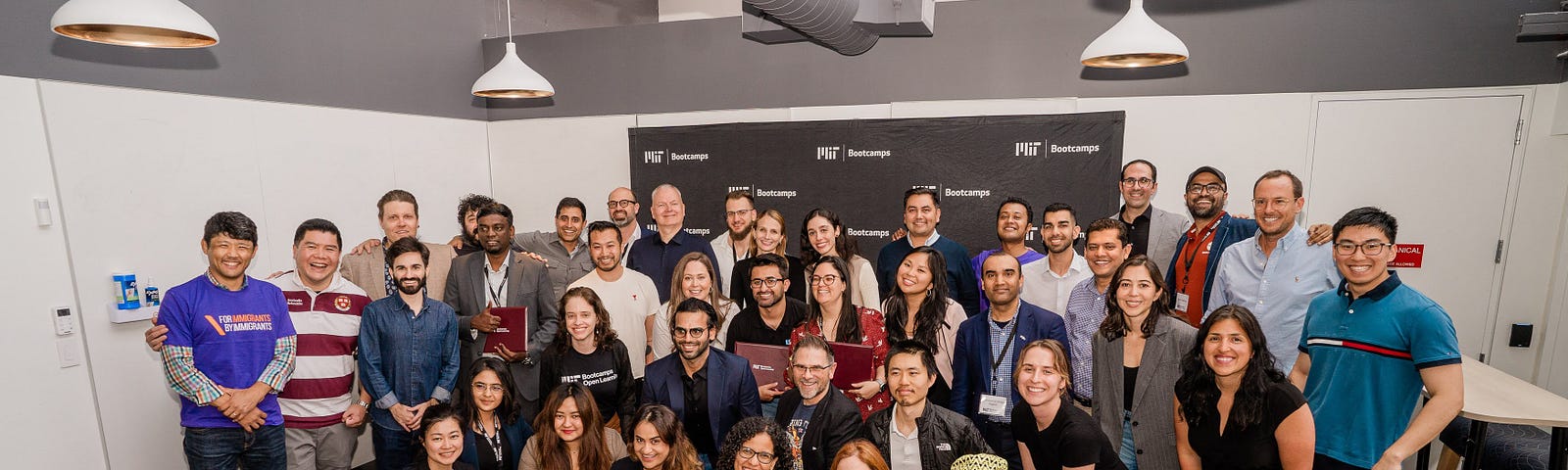 A large group of people smiling at the camera.