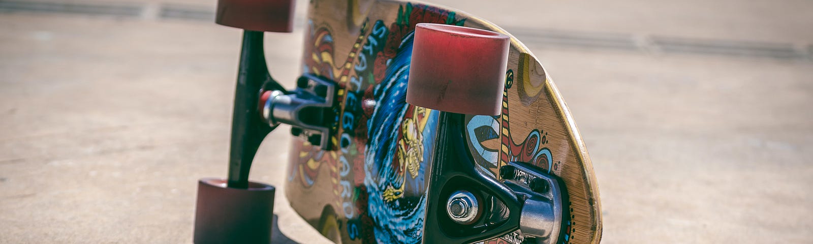 Close-up of a skateboard lying on its side.