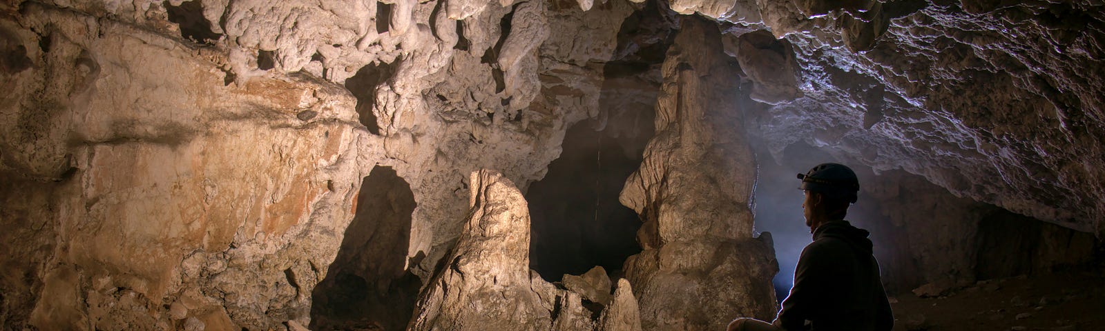 A man sitting in a cave.