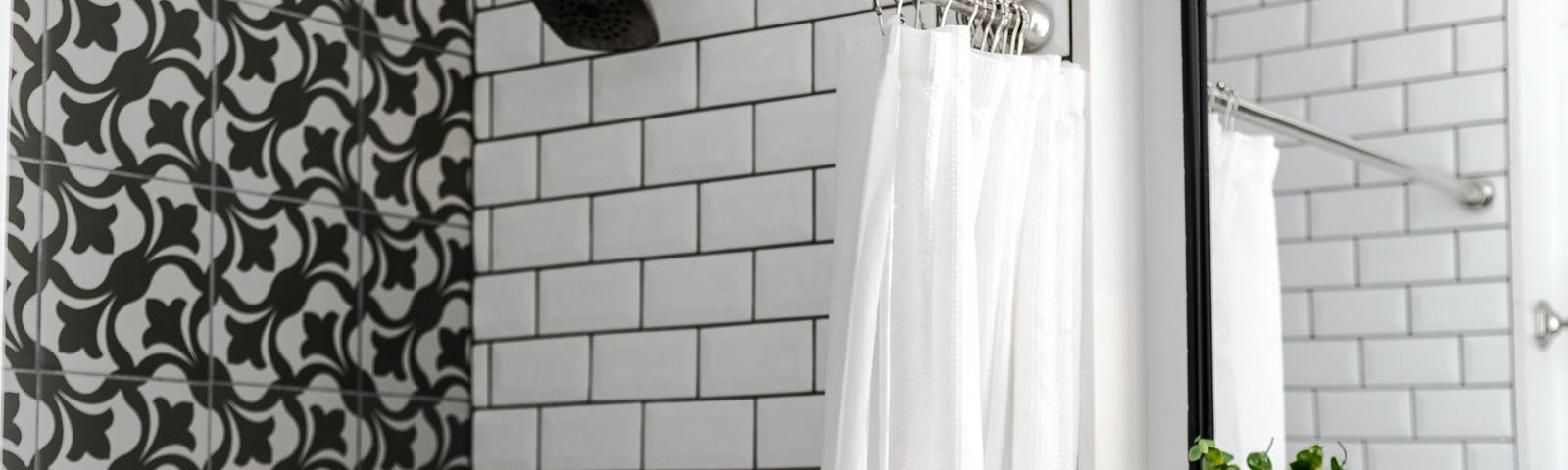 black & white tiled shower, white shower curtain open