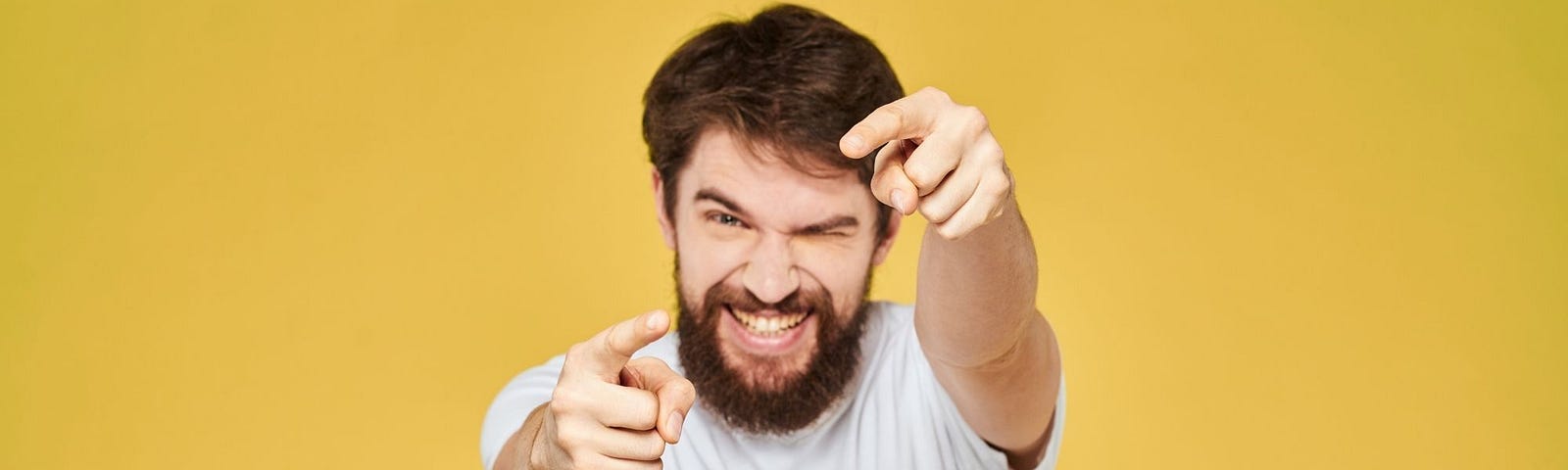 Gary, 25, with Hypersocial Disorder, Meets a Girl at the Support Group — A Bearded Man on a Yellow Background Makes a Shot Gesture