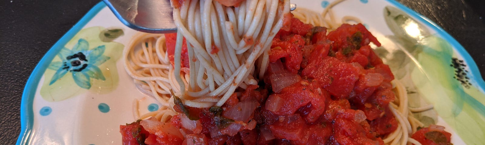 A plate of plant-based spaghetti sauce served over spaghetti noodles.