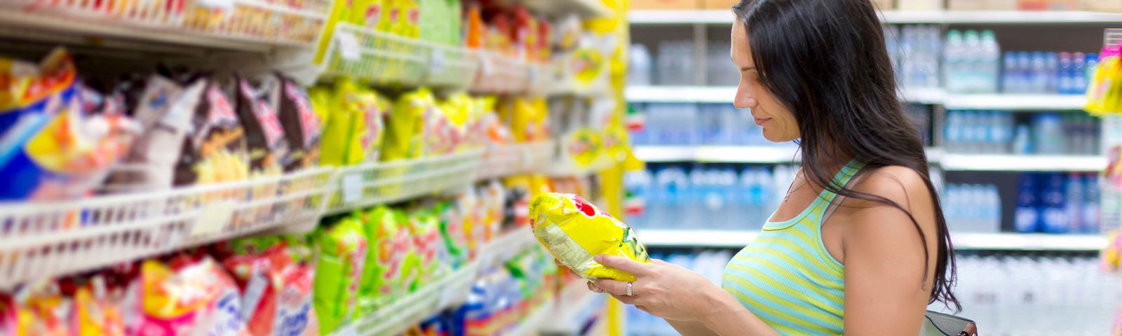 Woman Reading Labels in Grocery Store in Why Most Diet Advice Fails (And How to Find What Works For You)