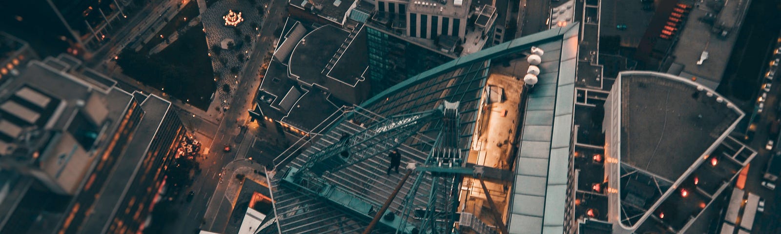 A man looking at the city from a high building