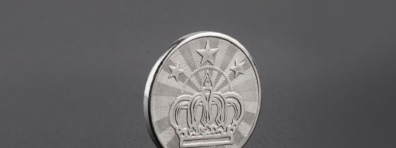 A mysterious coin for special machines. It has three stars at the top and a big crown on it.