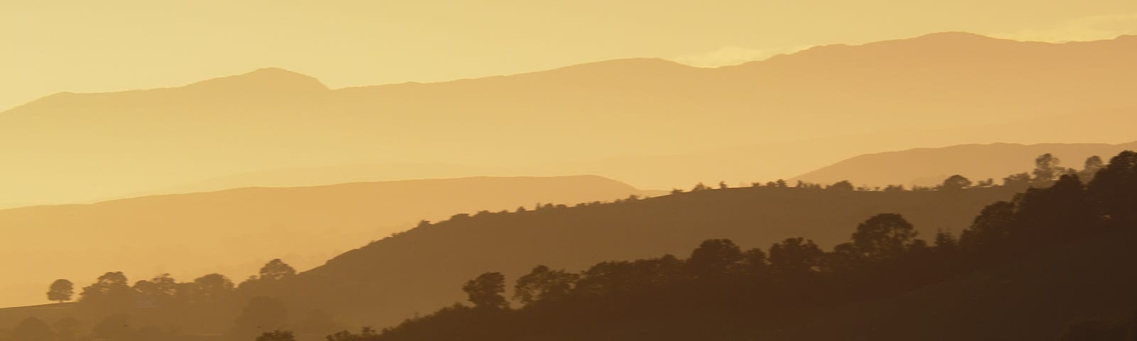 A view across the Welsh Hills from the Kerry Ridgeway towards Snowdonia in graduated sepia tones.