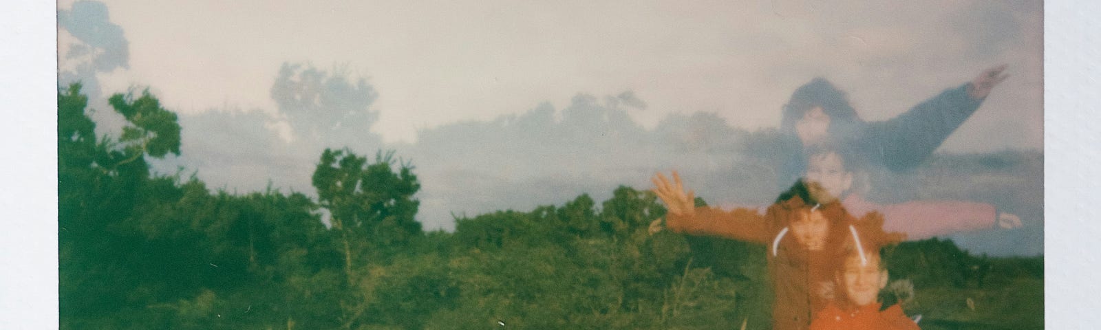 A Polaroid picture reveals some people obscured from view by their movements amid a foggy backdrop.