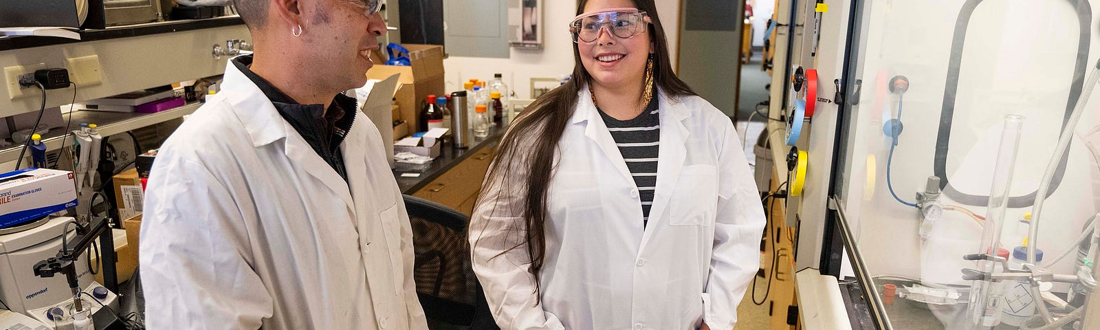 Aaron Thomas, director of UM Indigenous Research and STEM Education, speaks with Ph.D. student Sierra Paske in the Chemistry Building.