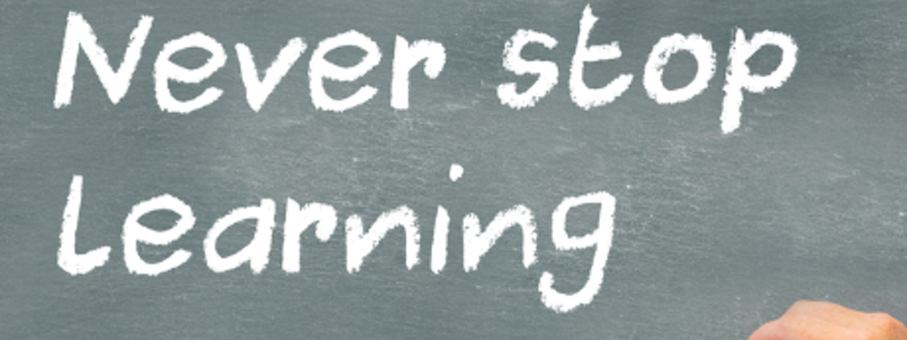 Chalkboard with the words Never stop Learning with Learning underlined