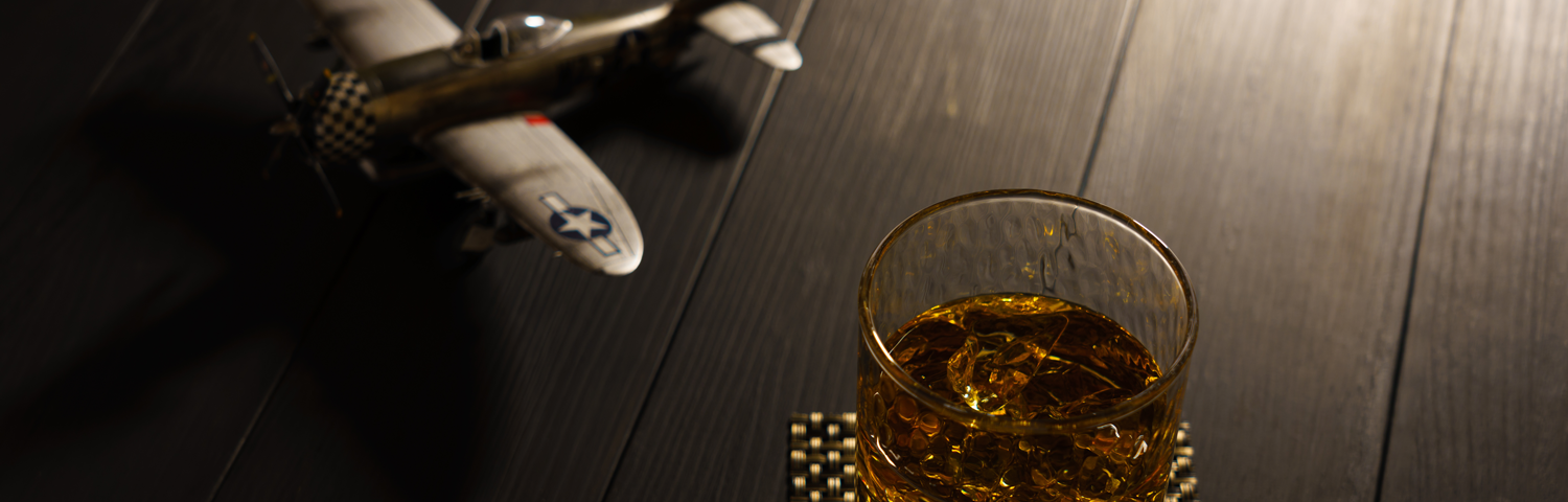 Photo of a toy airplane with a glass of whiskey.