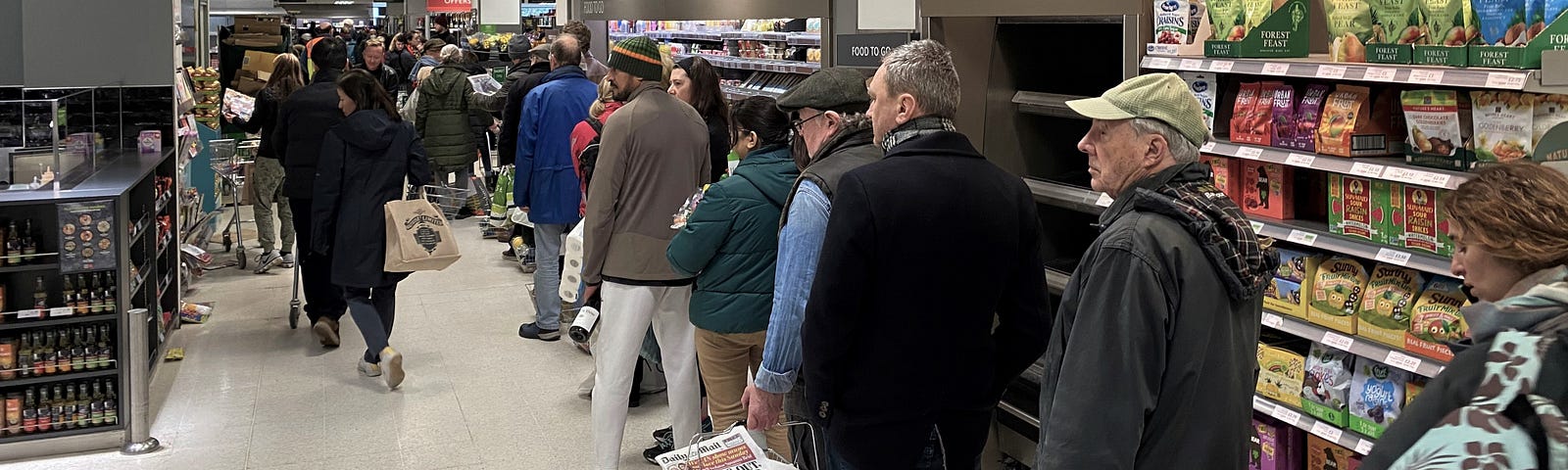 Line of people waiting at the supermarket.