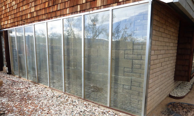 Picture of a Trombe wall, a passive solar heating and cooling system as a great way to reduce CO2 emissions, increase energy efficiency, and help mitigate climate change