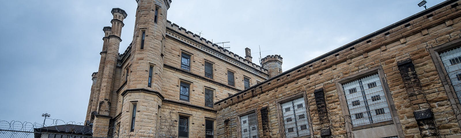 A gothic castle-like limestone structure with turrets and a gloomy sky.