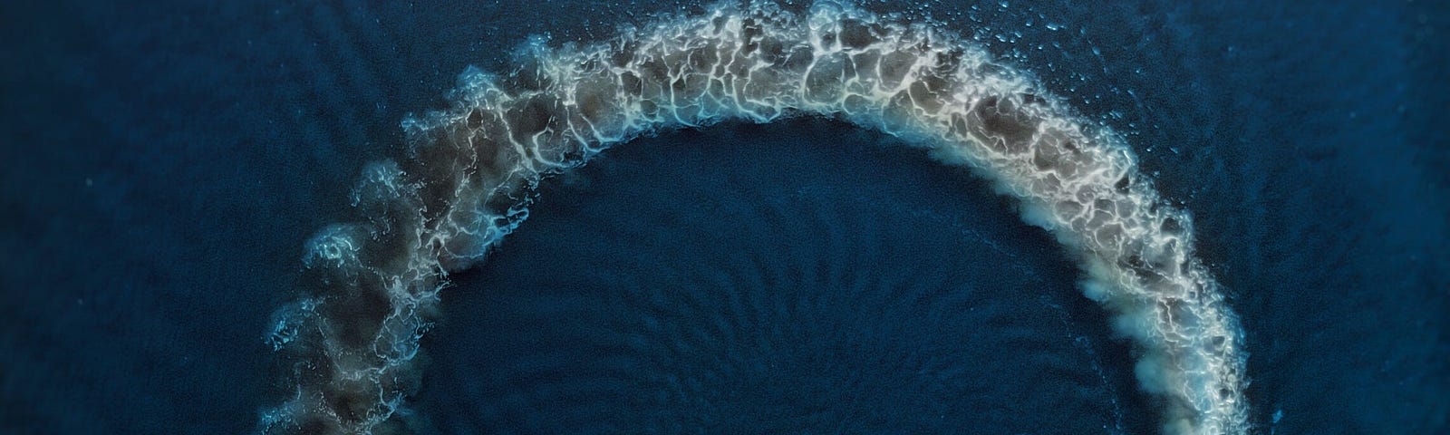 A photo of motor boat making circle on water surface.