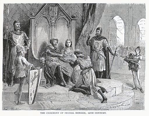 A black-and-white engraving that depicts a lord and lady on their thrones, holding a sword on the shoulder of a kneeling man, titled “The Ceremony of Feudal Homage, 12th century.”