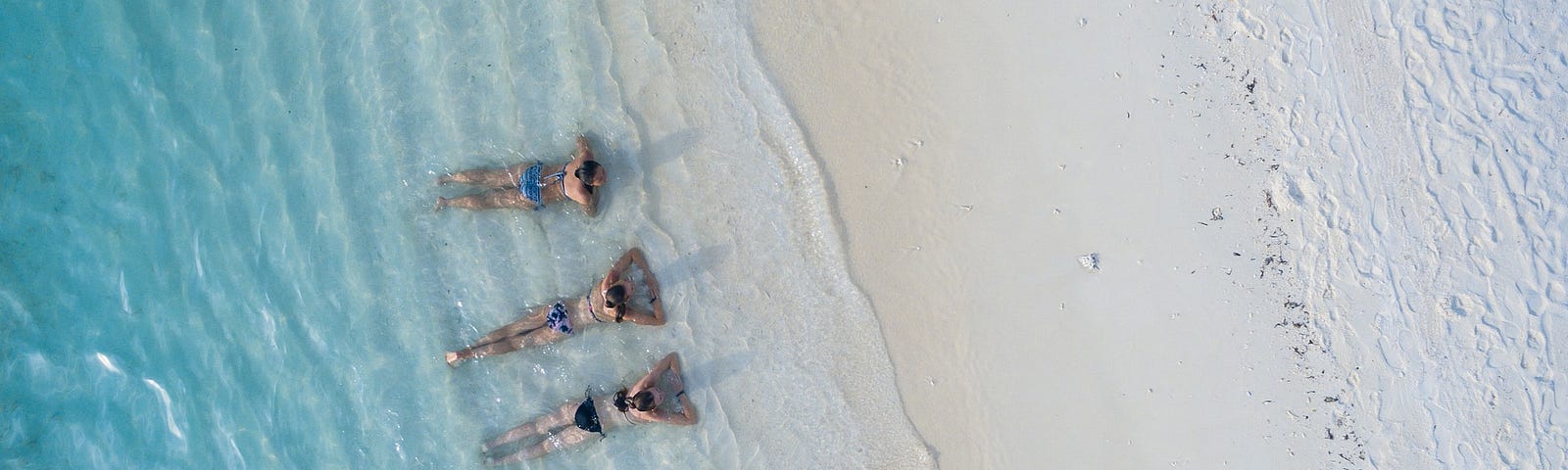 3 ladies resting by the beach.