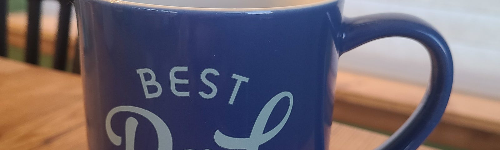 a blue coffee mug reading “Best Dad Ever”