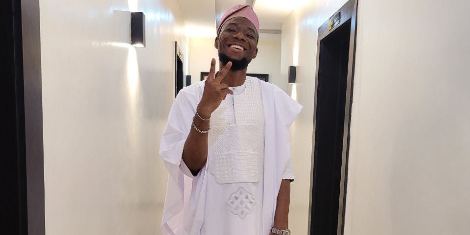Debayoorr wearing a traditional agbada.
