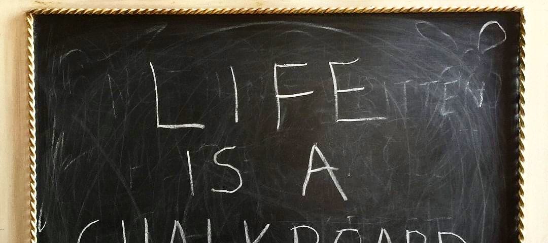 A fancy chalkboard with the words, “Life is a Chalkboard” written on it. Photo by Doodleslice 2017