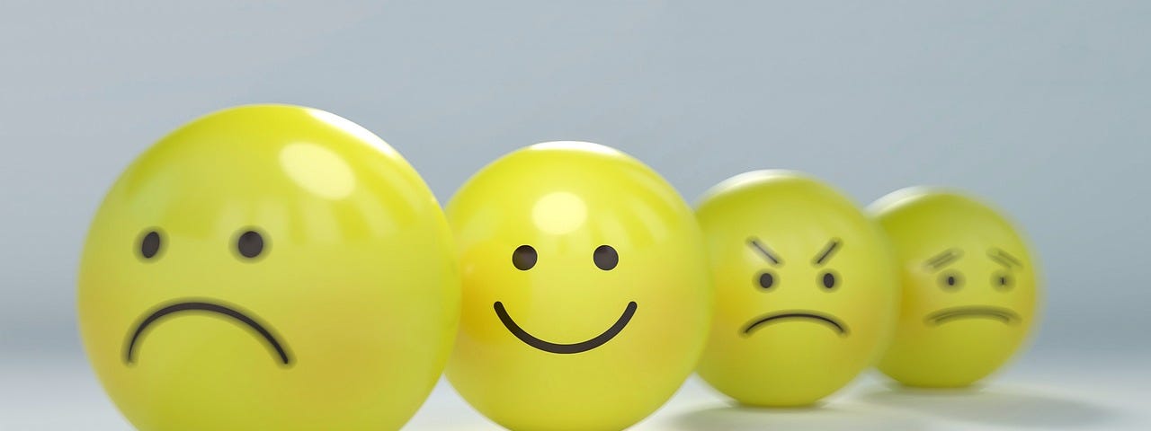 yellow smiley to angry faced emoji balls
