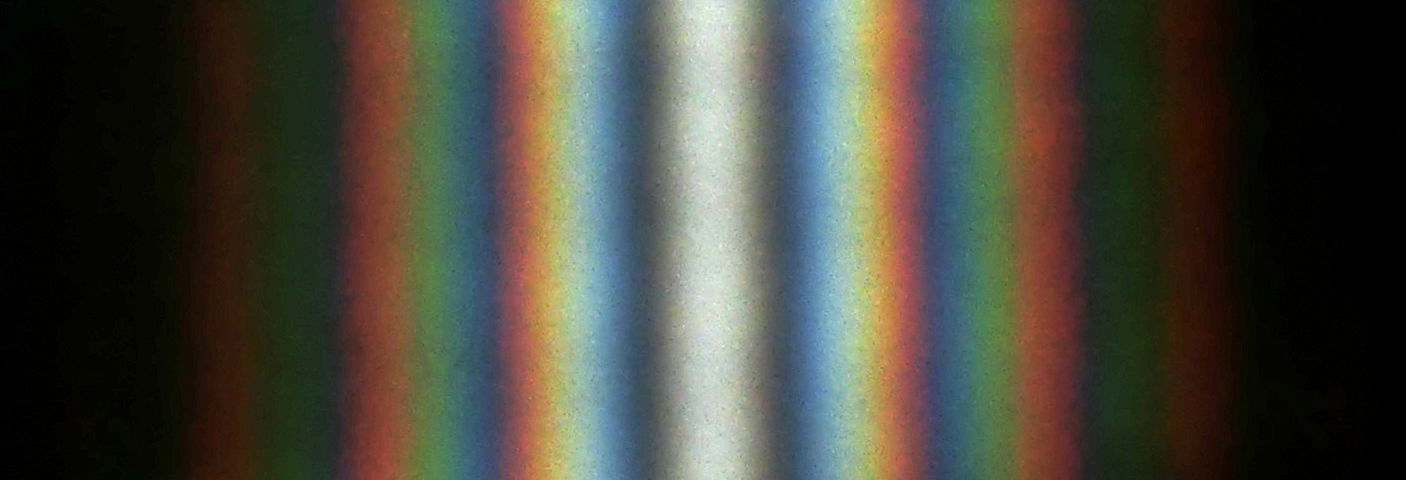 A double-slit interference of the sunlight passing through two slits ~1 cm long and ~0.5 mm apart. At the top and the bottom of the image, the interference on the edge of the slit produces a noticeable variation of the brightness. Image by Aleksandr Berdnikov at MIT.
 Distributed with no edits under free use graciously granted by the photographer.