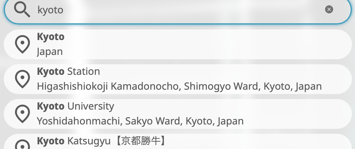 A search box with semi-circle edges on both sides shows the search term _kyoto_, below which five boxes of the shape similar to the search box show autocomplete suggestions: Kyoto, Kyoto Station, Kyoto University, Kyoto Katsugyu, and Kyoto Railway Museum. In these suggestions, the phrase _Kyoto_ is highlighted in bold.
