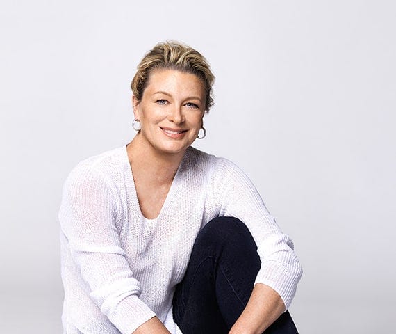Kristin Hannah sits in casual pose