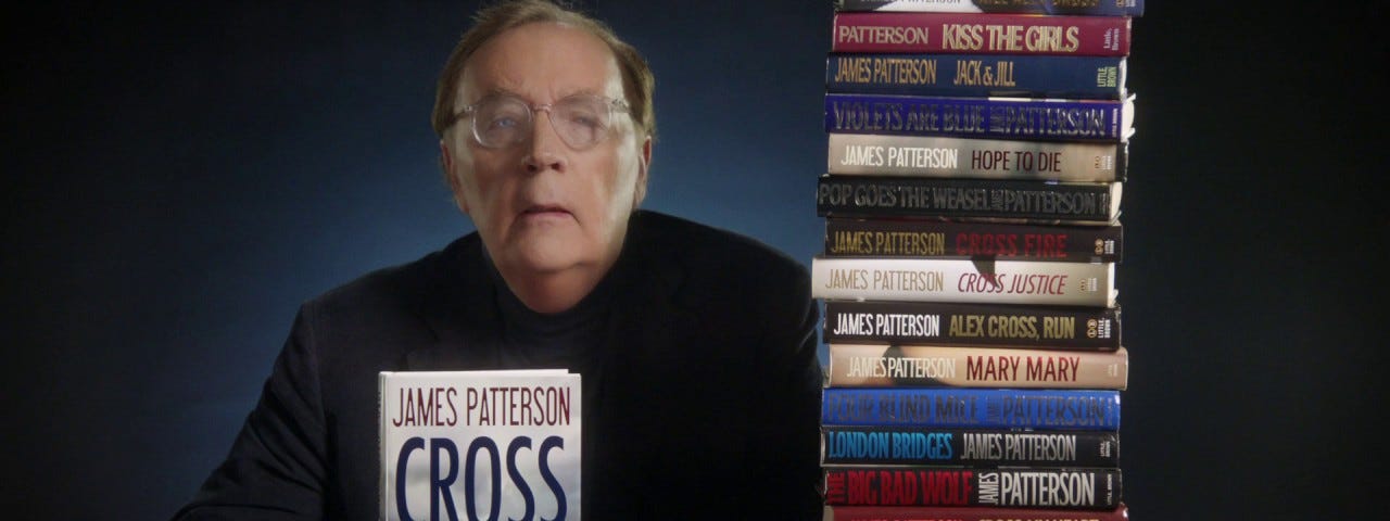 James Patterson with a pile of Alex Cross novels.