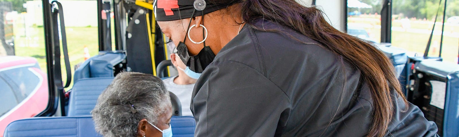 Woman receiving vaccine on a bus